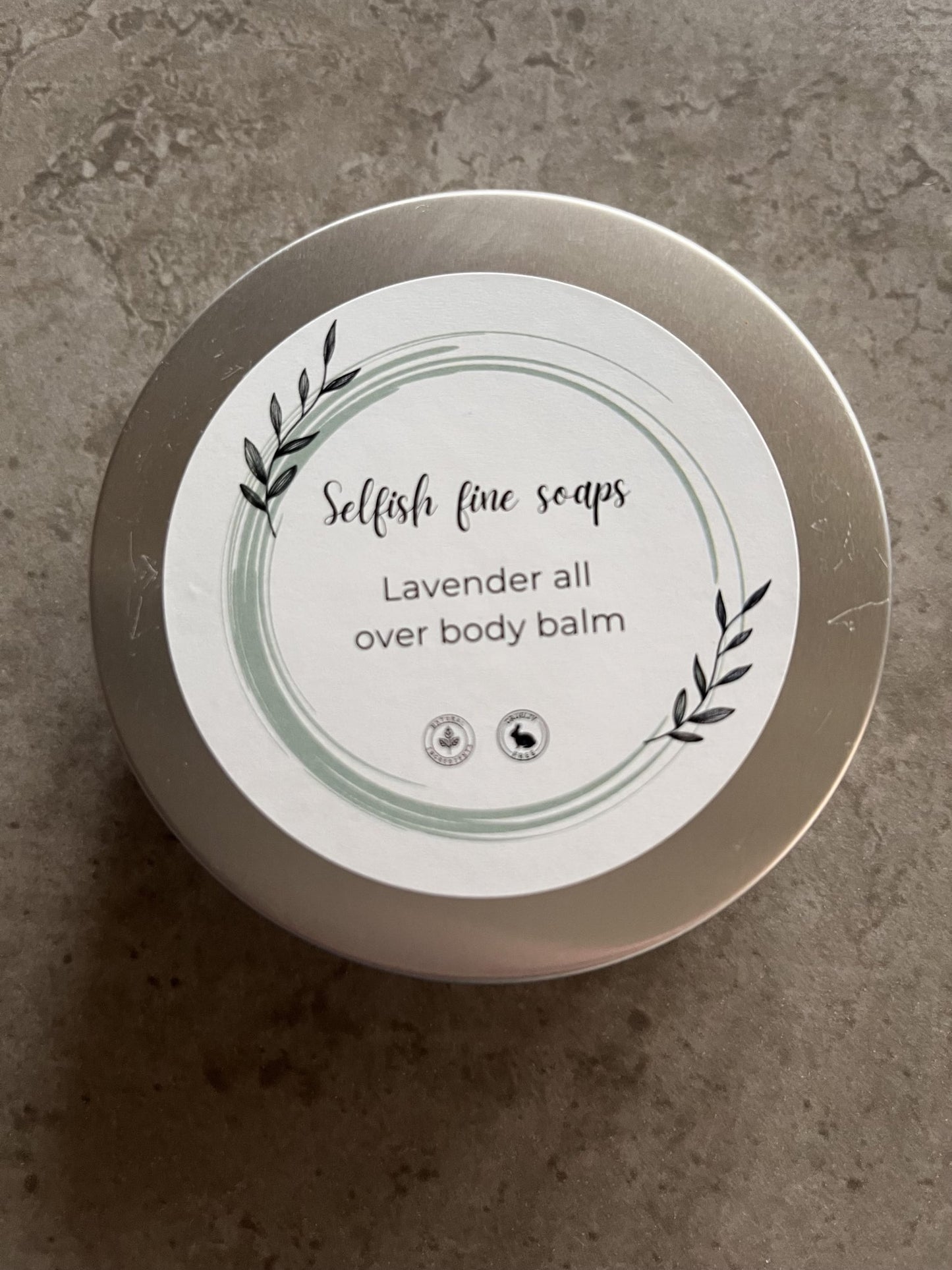 Lavender all over body balm - Selfish Fine Soaps. This is a round tin of lavender body balm made from natural ingredients which are great for softening and hydrating dry hard skin. Wonderful for use on feet after exfoliation for an over night treatment.