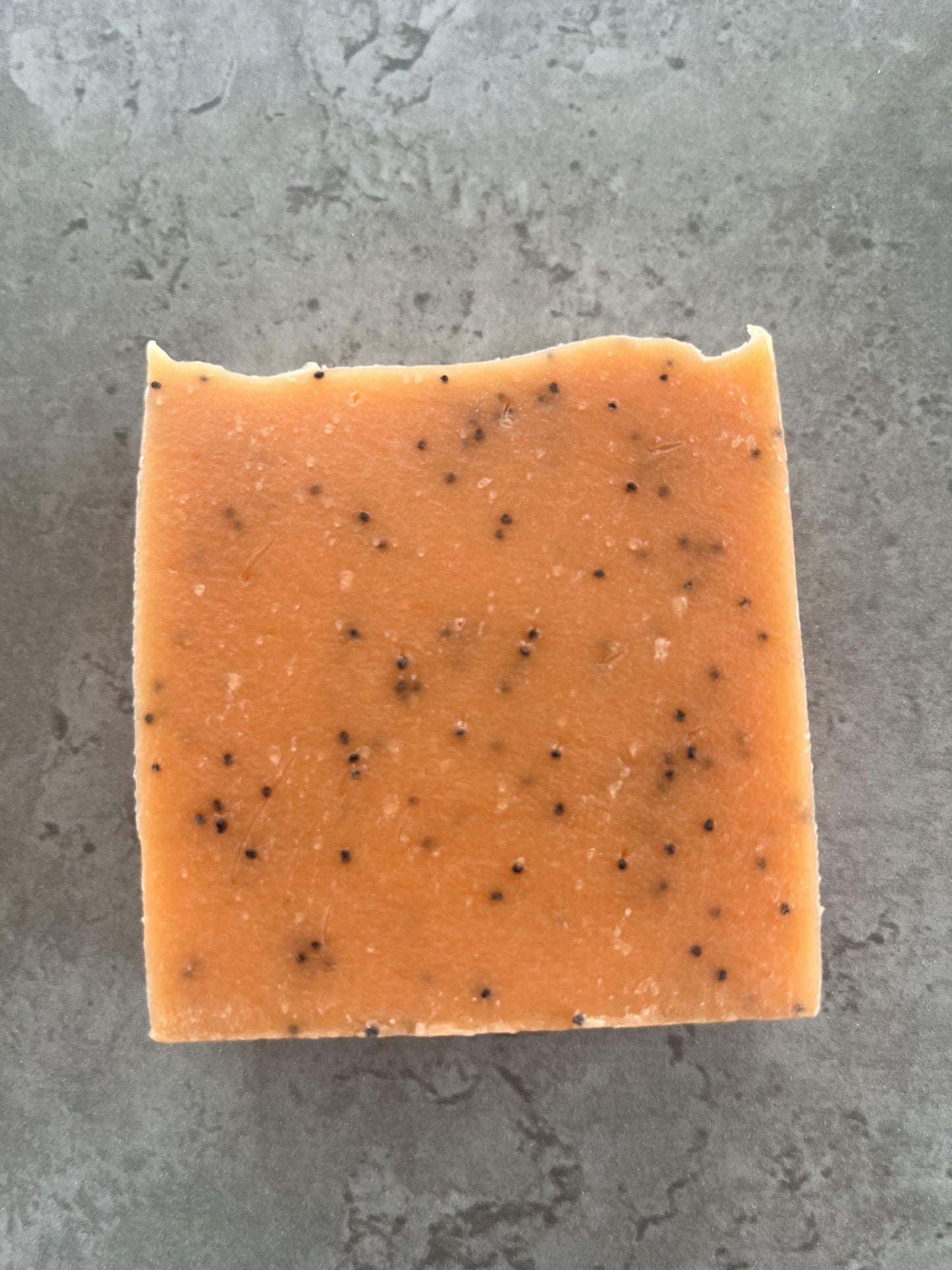 Orange, Amber and poppy seed cold processed soap - Selfish Fine Soaps. This is a bar of orange cold processed soap with poppy seeds throughout it for exfoliation. It is perfumed with Orange and amber fragrance oil and smells gorgeous. It is one of the best selling bars we make people love it.