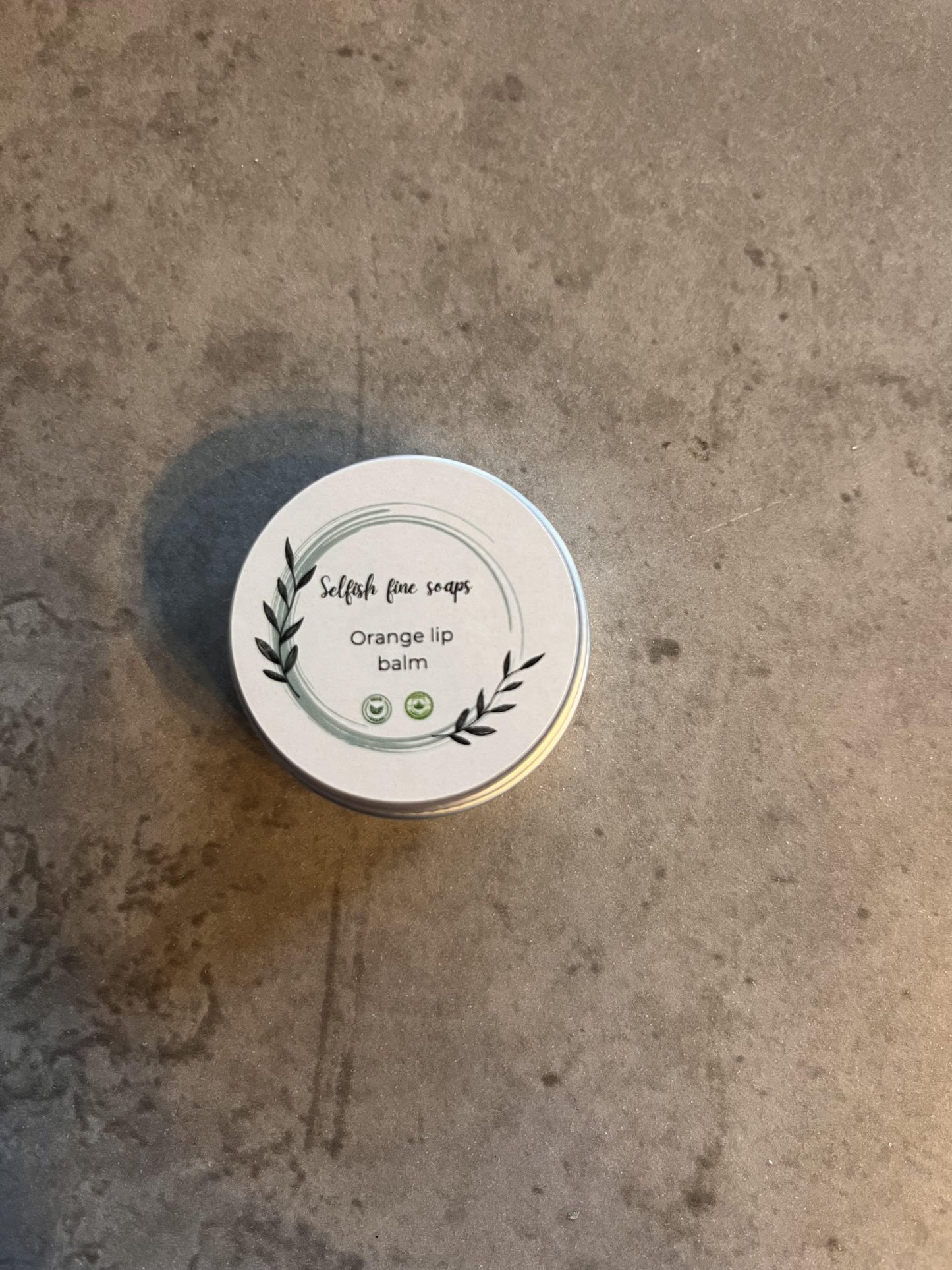 Lip balm selection pack. - Selfish Fine Soaps. This is a small round tin of handmade lip balm. It is made from natural ingredients and enriched with orange essential oil to nourish and moisturise your lips all day.