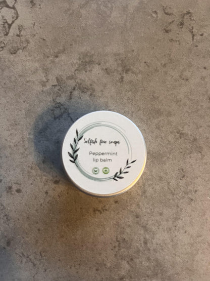 Peppermint lip balm - Selfish Fine Soaps. This is a small tin of handmade lip balm. It is made from fully natural vegan friendly ingredients and enriched with peppermint essential oil.