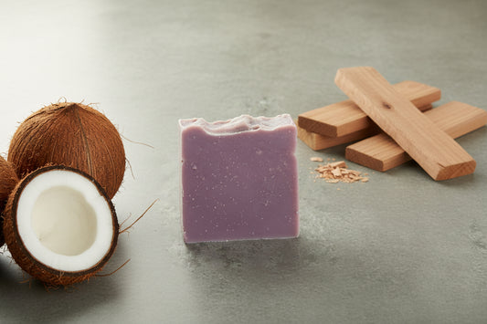 Purple soap bar on a gray concrete surface